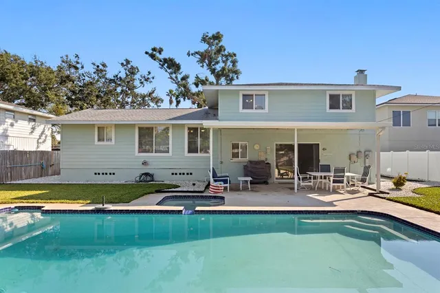 a view of a swimming pool with an outdoor space and seating area