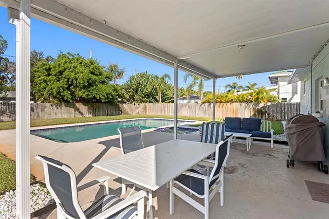 an aerial view of residential houses with outdoor space and swimming pool