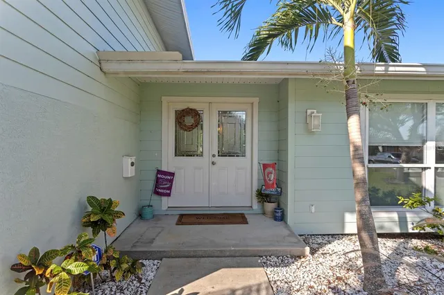 a living room with furniture a ceiling fan and a flat screen tv
