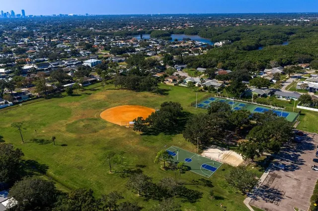 an aerial view of a house with swimming pool and patio