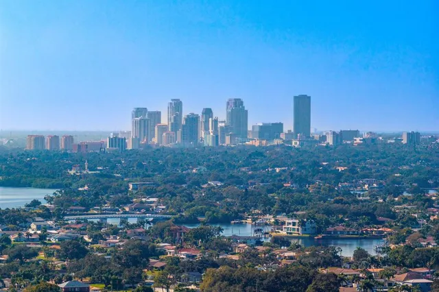 a view of a house with swimming pool and sitting area