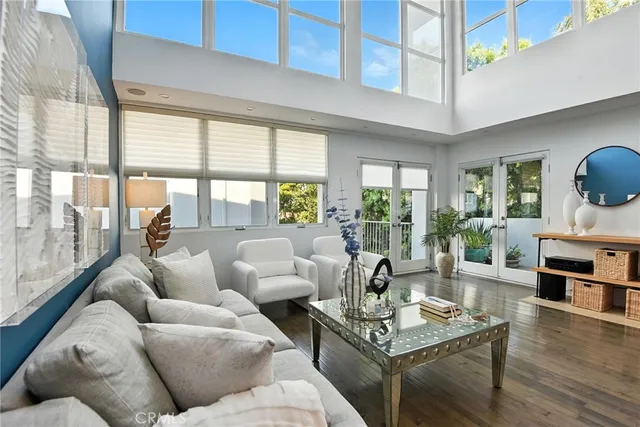 a living room with fireplace furniture and a large window