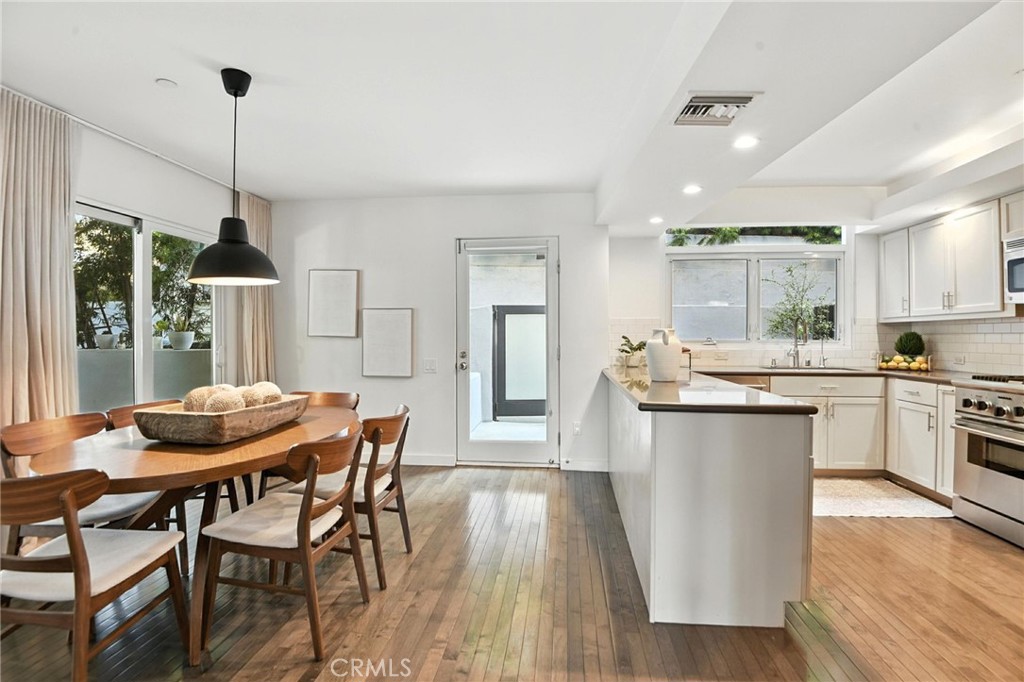 2203 3rd Street, Unit 1 Santa Monica, CA 90405 - Photo 13 of 46 a kitchen with stainless steel appliances granite countertop a kitchen island hardwood floor and a sink