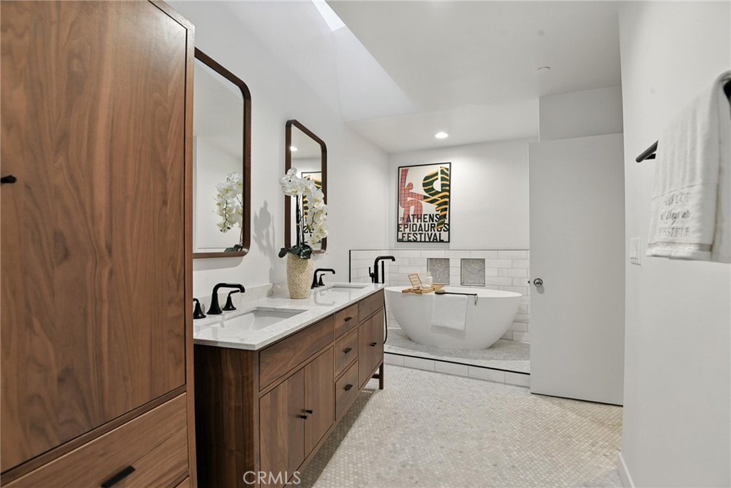 2203 3rd Street, Unit 1 Santa Monica, CA 90405 - Photo 32 of 46 a bathroom with a double vanity sink and mirror