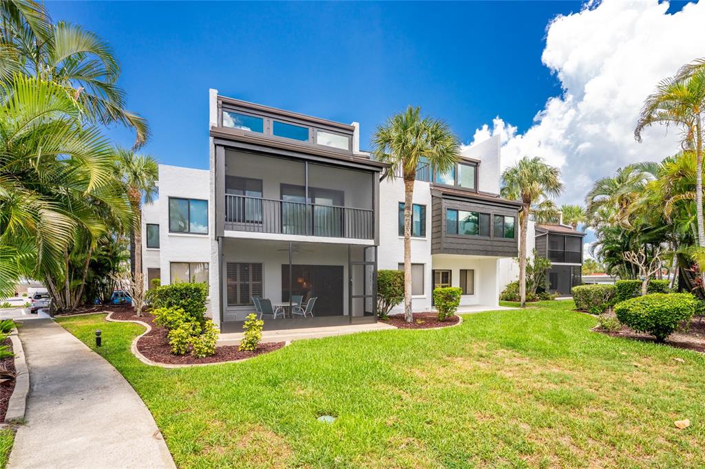 2955 North Beach Road, Unit B614 Englewood, FL 34223 - Photo 37 of 67 a view of a building with a yard