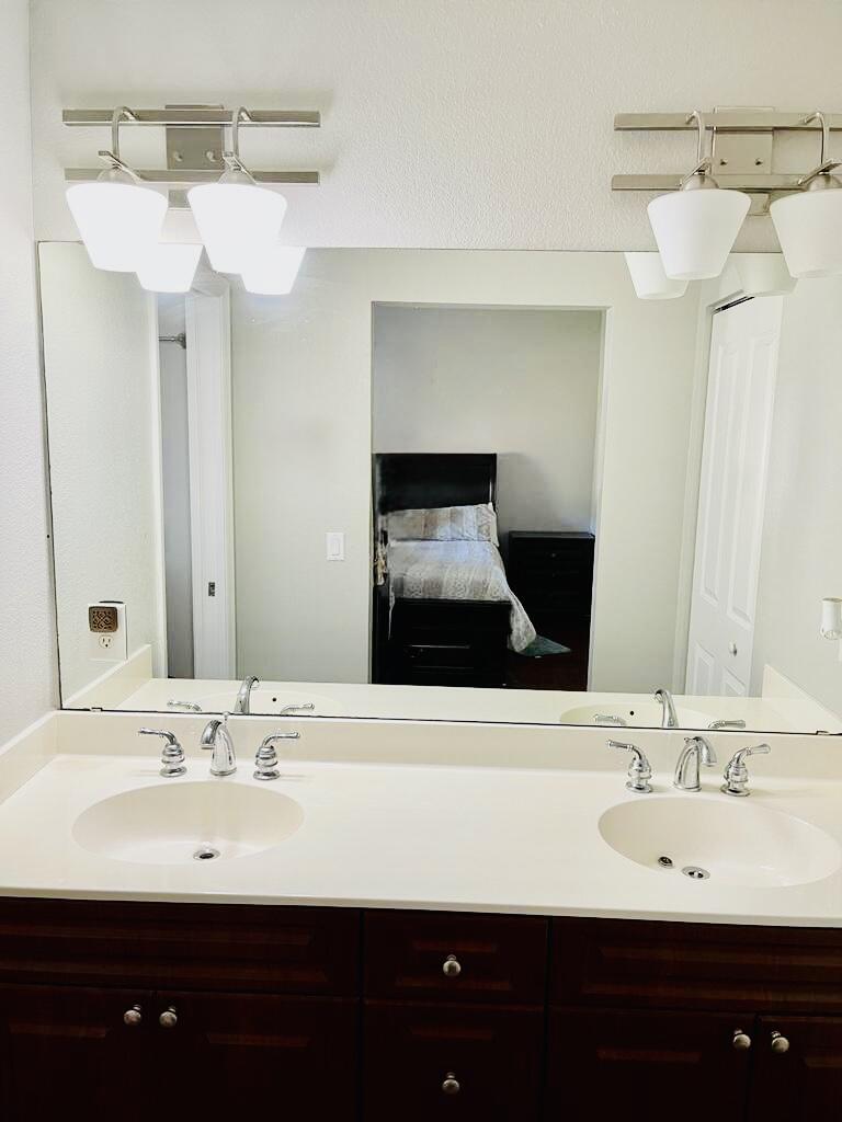 9745 Touchton Road, Unit 1726 Jacksonville, FL 32246 - Photo 18 of 40 a bathroom with a sink and a mirror