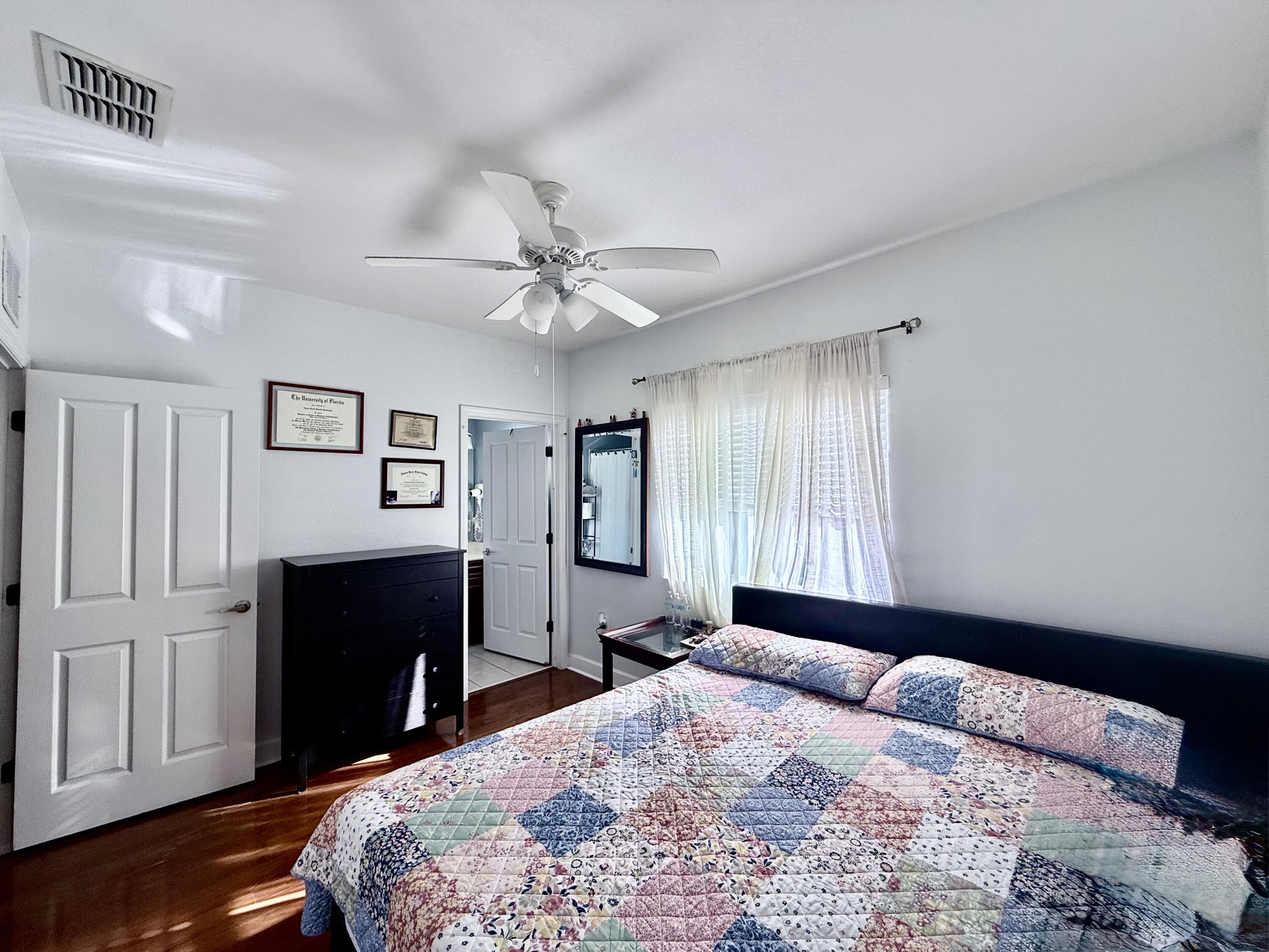 9745 Touchton Road, Unit 1726 Jacksonville, FL 32246 - Photo 20 of 40 a bedroom with a bed and a chandelier