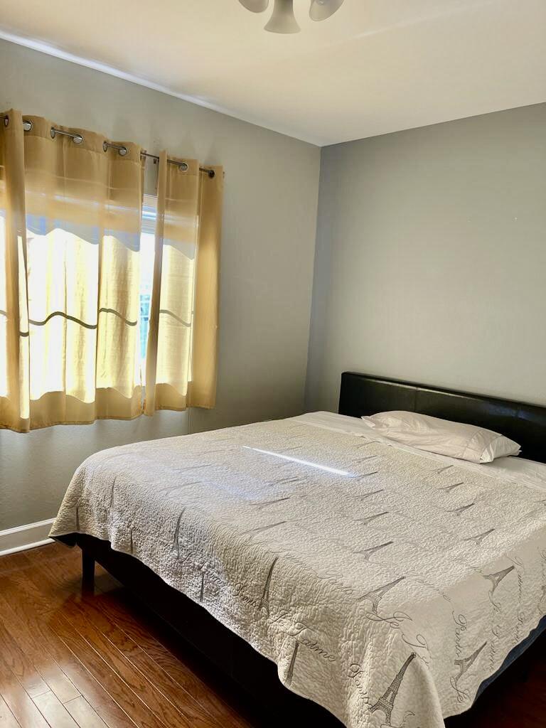 9745 Touchton Road, Unit 1726 Jacksonville, FL 32246 - Photo 22 of 40 a bedroom with a bed and wooden floor