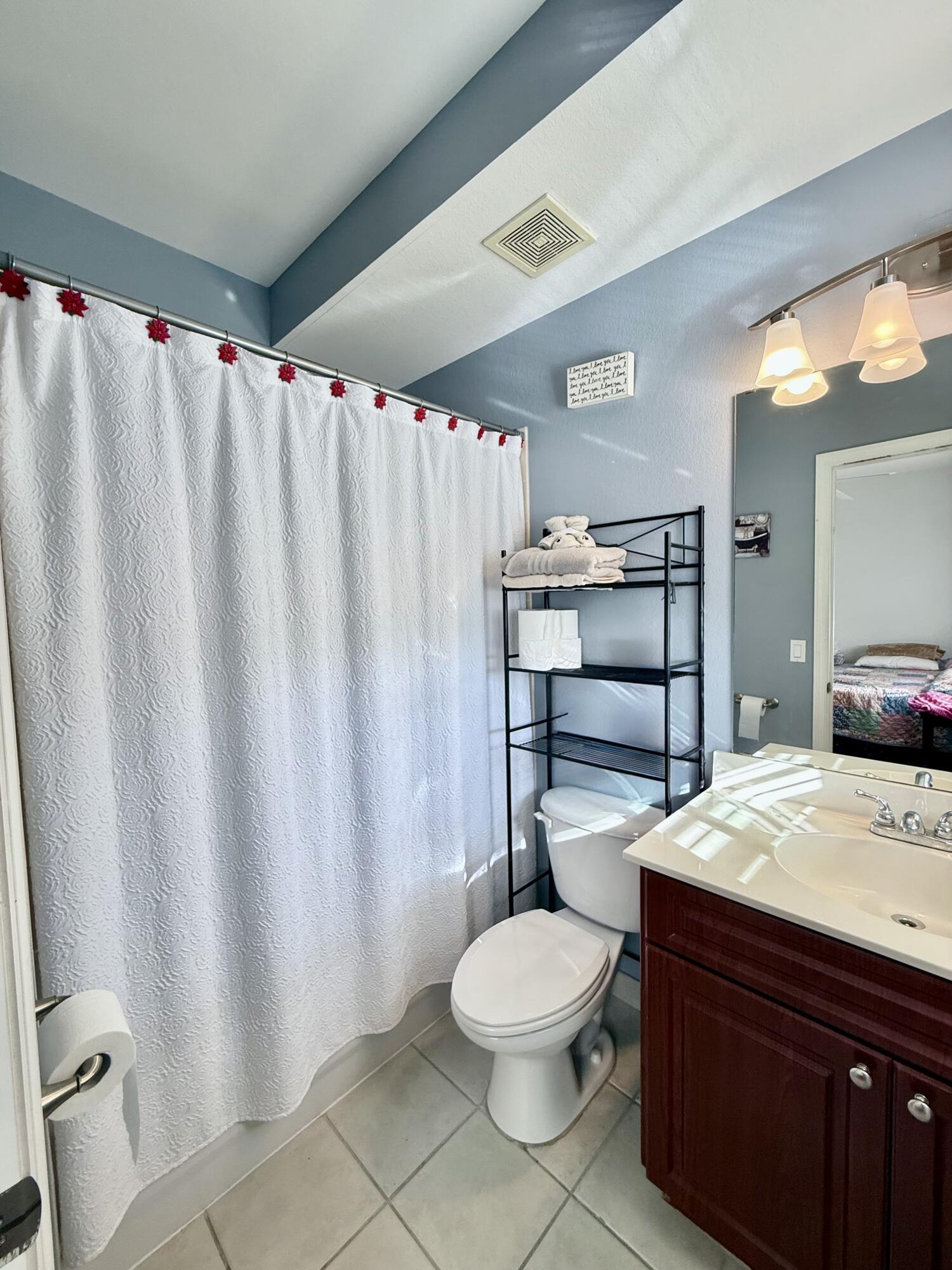 9745 Touchton Road, Unit 1726 Jacksonville, FL 32246 - Photo 23 of 40 a bathroom with a sink a toilet and shower