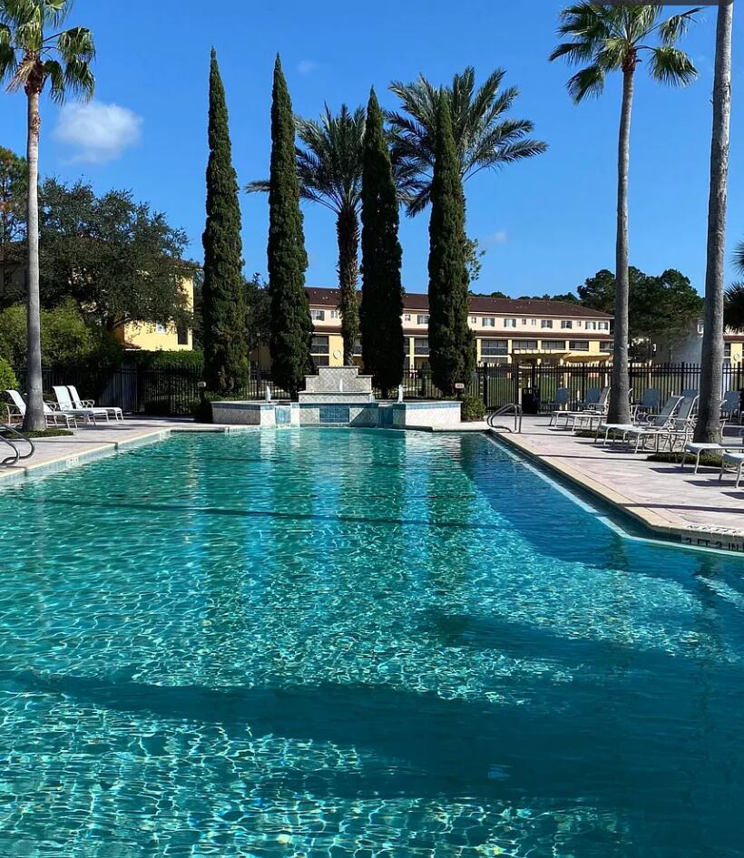 9745 Touchton Road, Unit 1726 Jacksonville, FL 32246 - Photo 31 of 40 a view of a swimming pool and tall trees