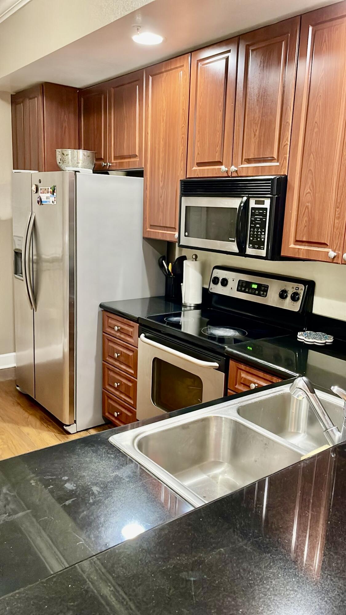 9745 Touchton Road, Unit 1726 Jacksonville, FL 32246 - Photo 6 of 40 a kitchen with stainless steel appliances granite countertop a refrigerator a stove a sink and a microwave