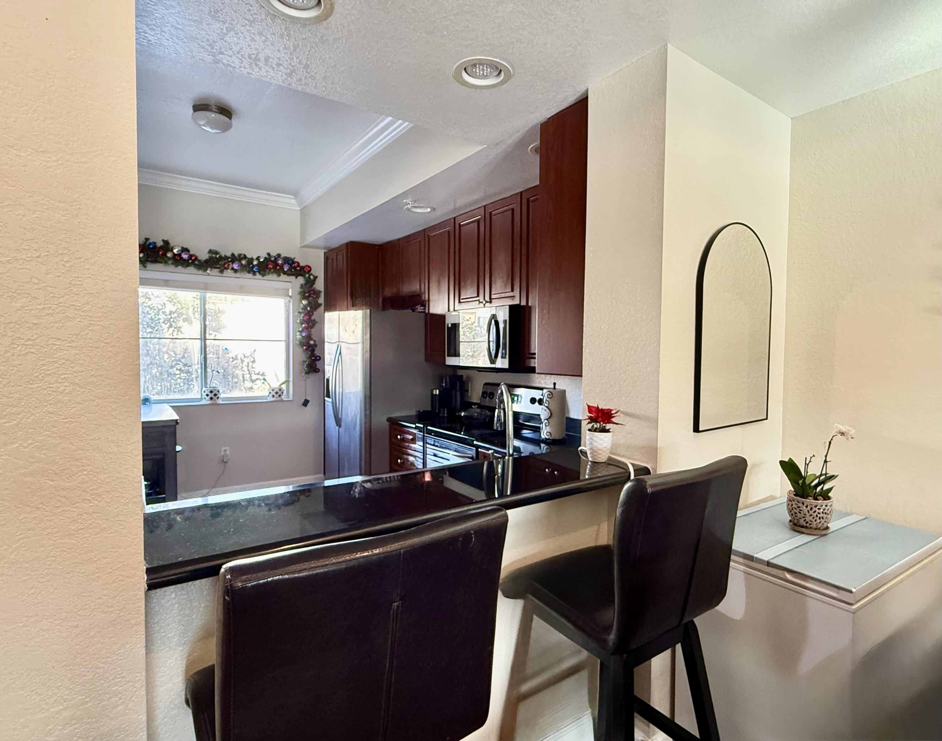 9745 Touchton Road, Unit 1726 Jacksonville, FL 32246 - Photo 7 of 40 a kitchen with a table and chairs