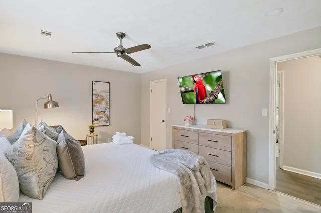 a bedroom with a bed and a tv on the dresser