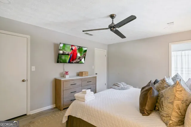 a bedroom with a bed and a flat tv screen