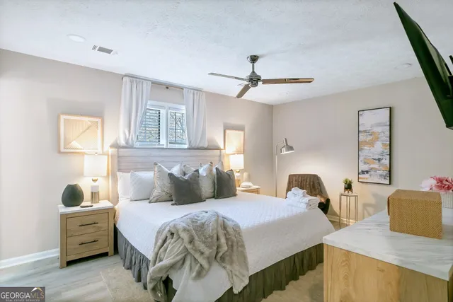 a bedroom with two beds and a chandelier