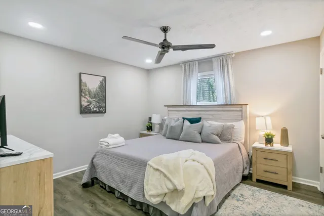 a bedroom with a large bed and a chandelier
