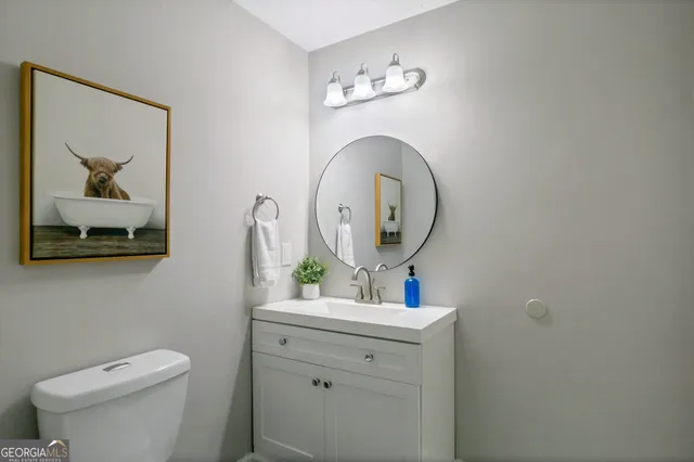 a bathroom with a toilet a sink and mirror