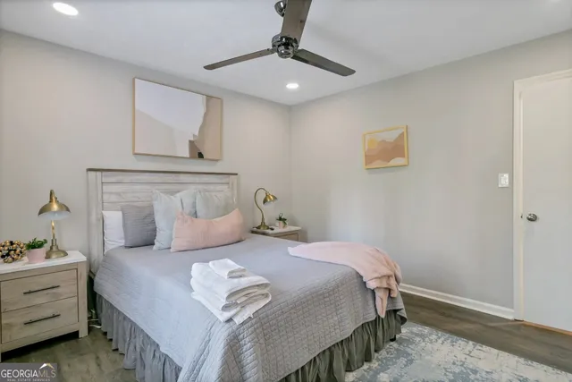 a bedroom with a bed and a potted plant