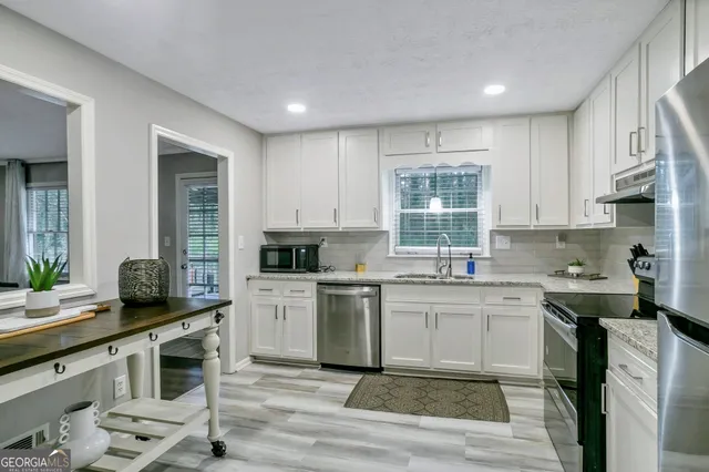 a kitchen with a sink cabinets and window