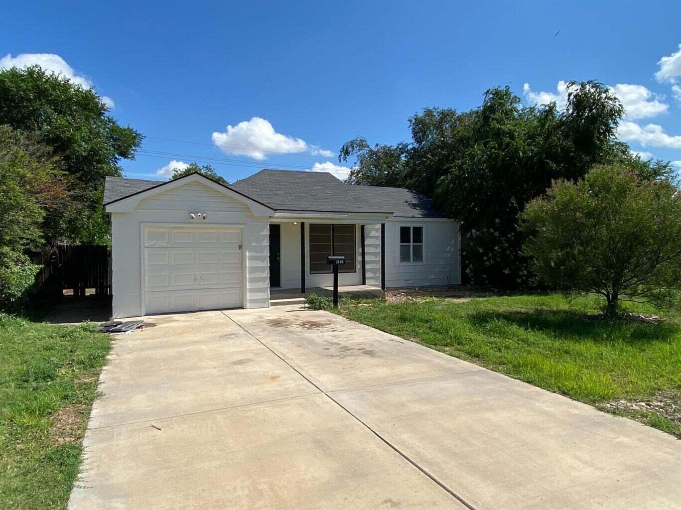 3116 33rd Street Lubbock, TX 79410 - Photo 1 of 7 a front view of a house with garden