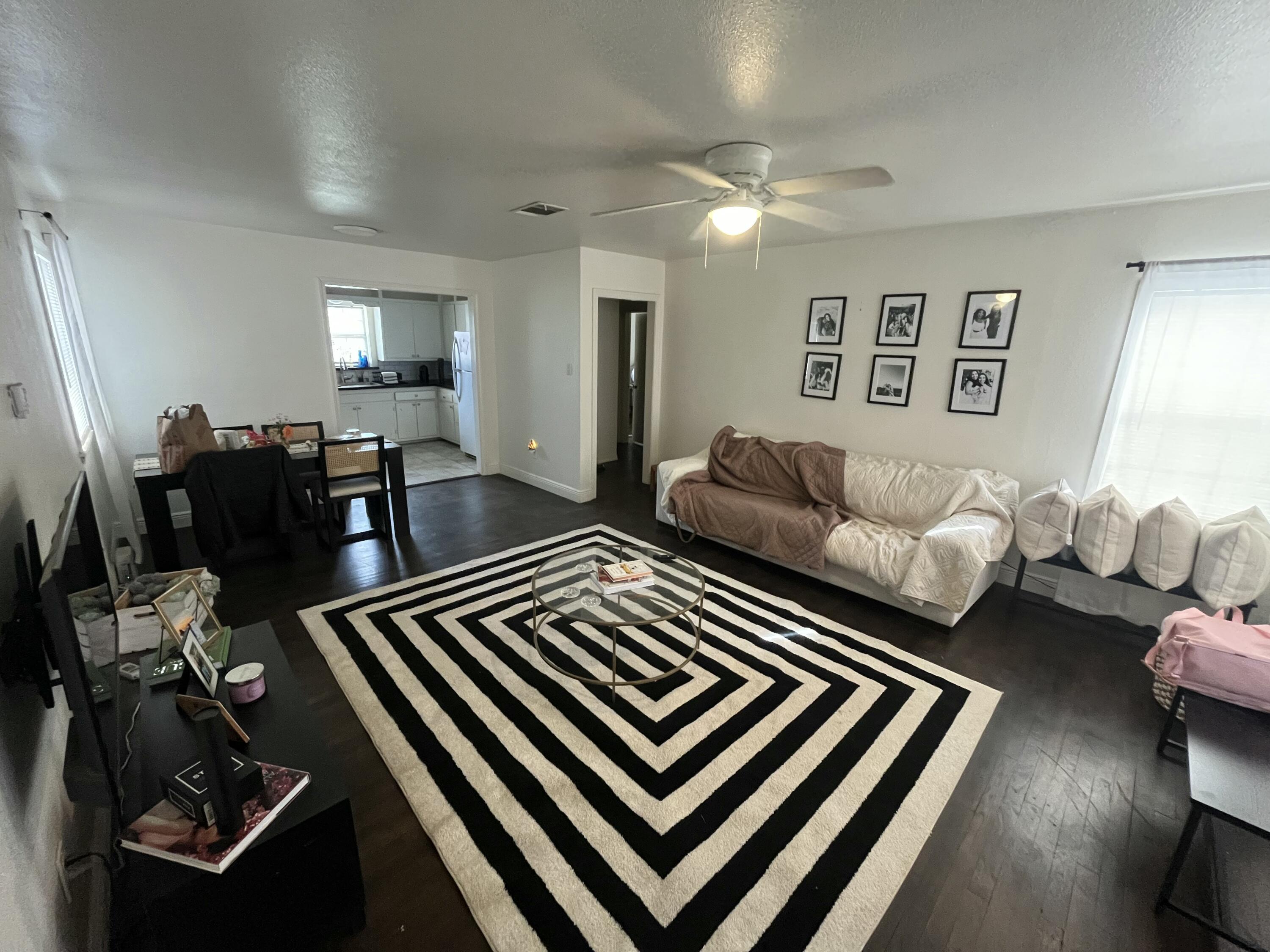 3116 33rd Street Lubbock, TX 79410 - Photo 3 of 7 a living room with furniture and wooden floor