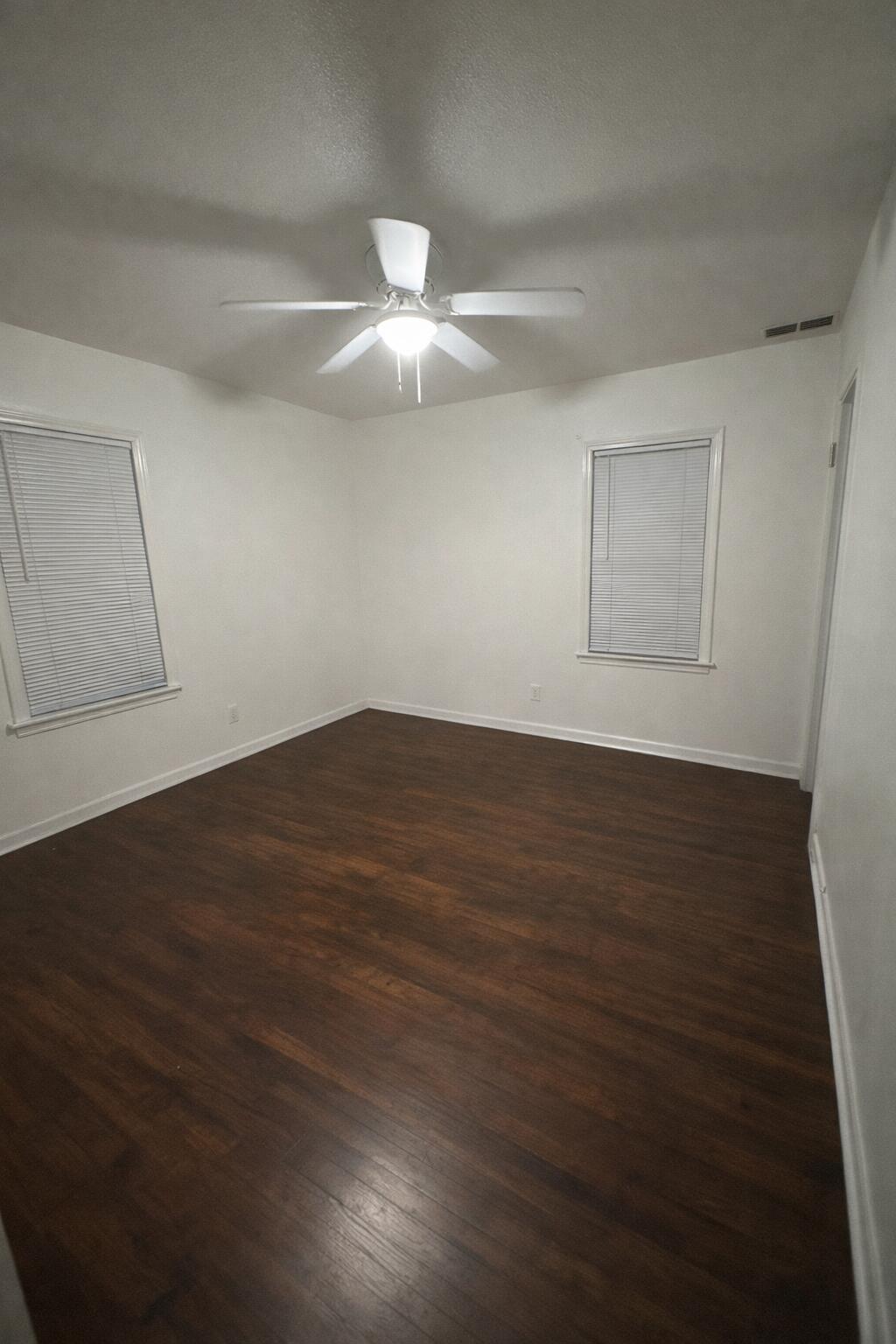 3116 33rd Street Lubbock, TX 79410 - Photo 5 of 7 an empty room with wooden floor and fan