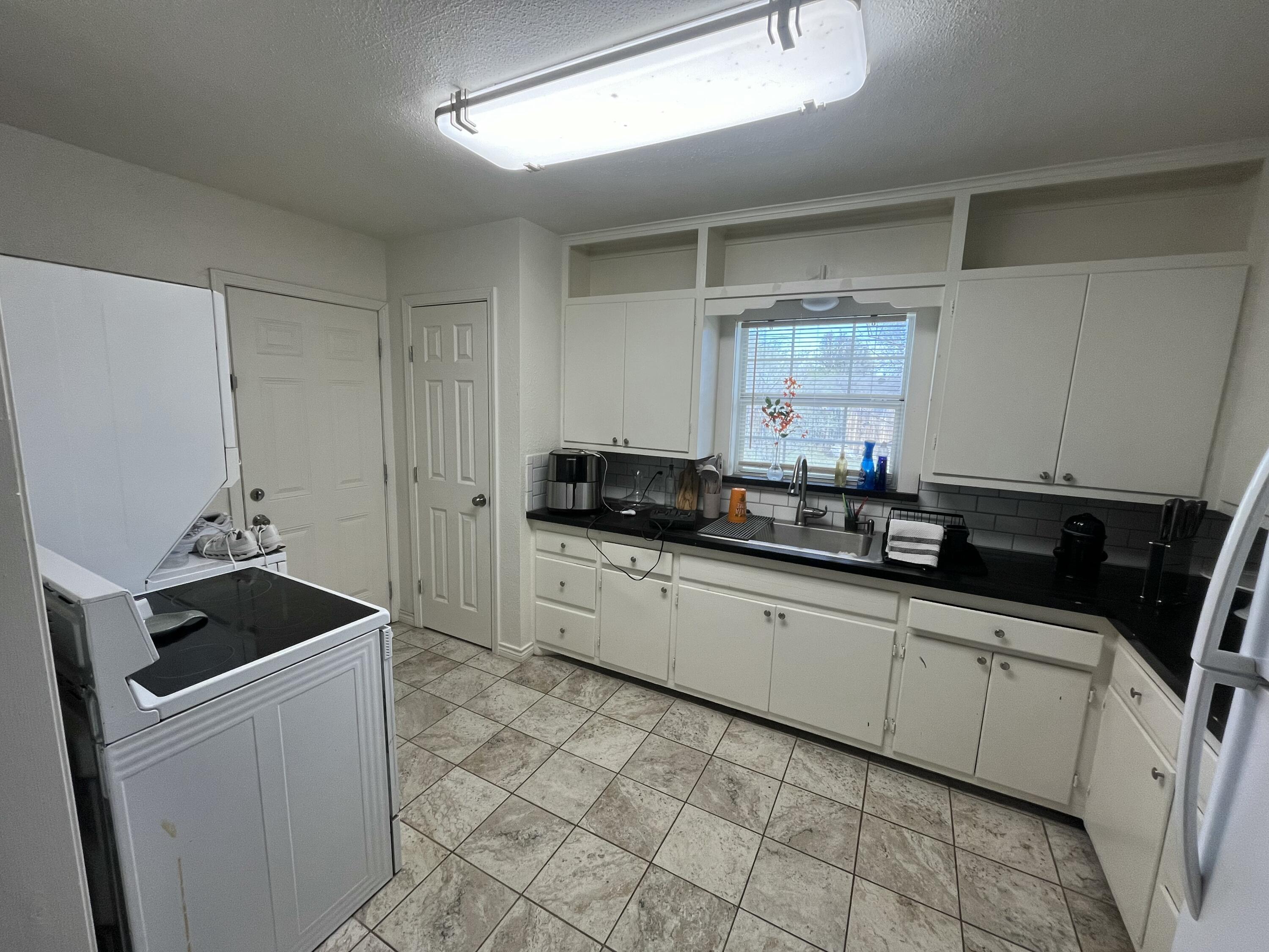 3116 33rd Street Lubbock, TX 79410 - Photo 7 of 7 a kitchen that has a sink and a stove
