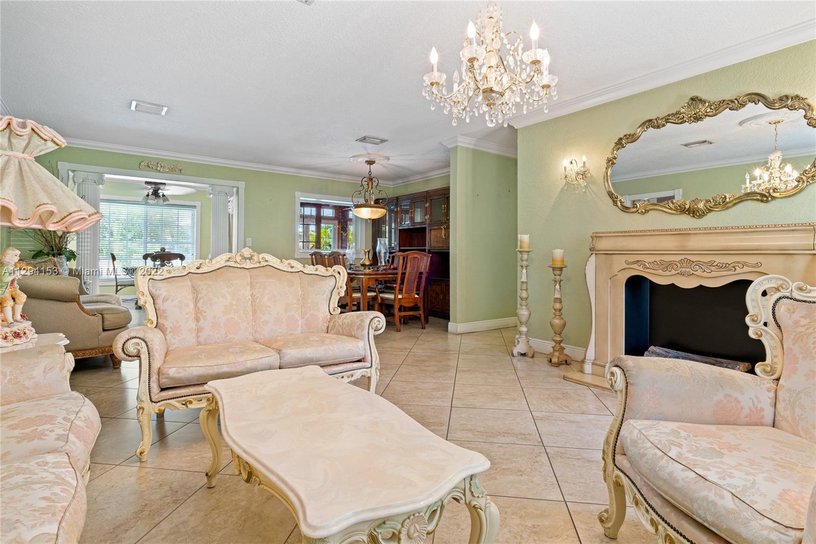 9901 Southwest 35th Terrace Miami, FL 33165 - Photo 11 of 50 a living room with furniture and a fireplace