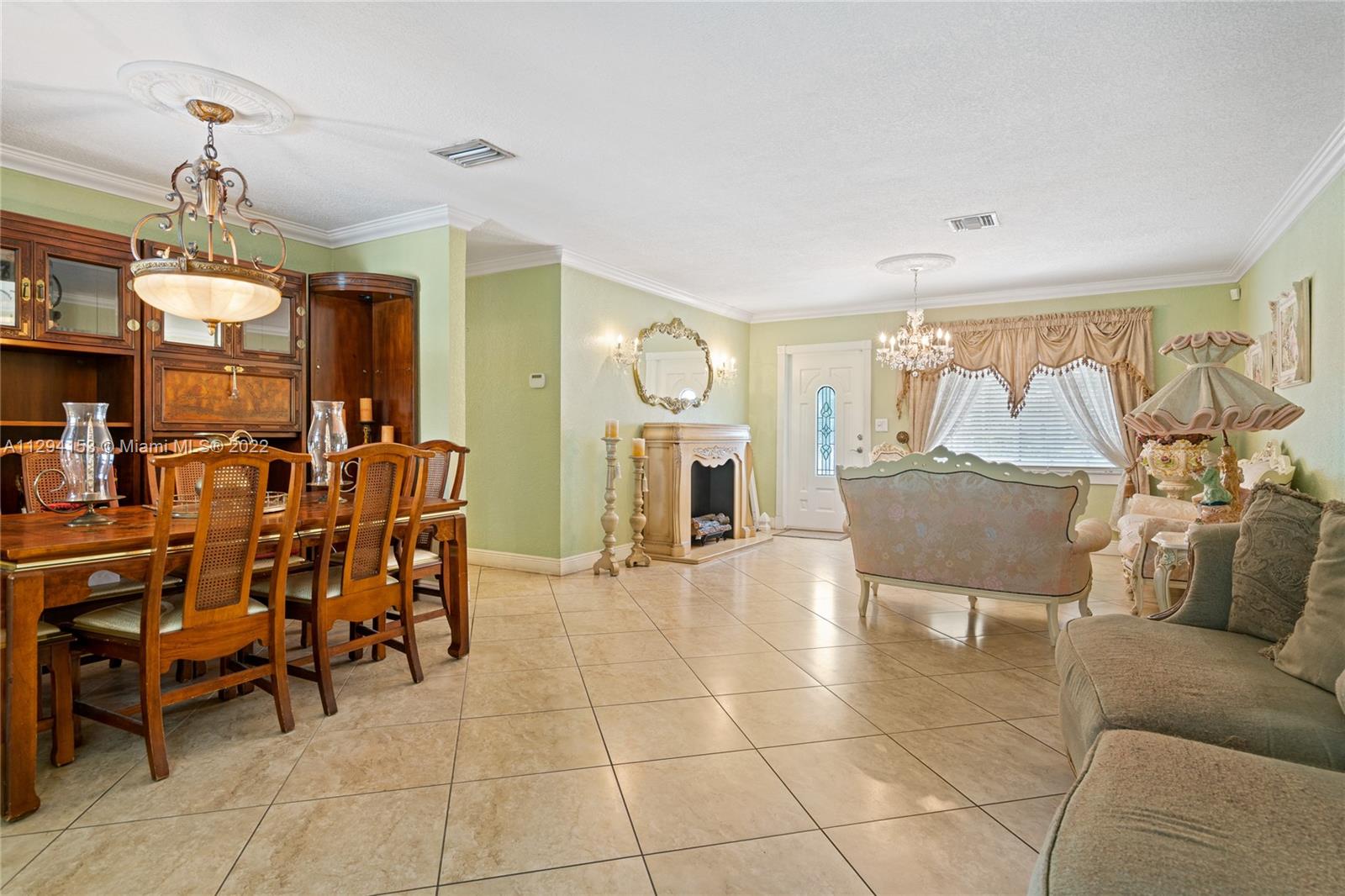 9901 Southwest 35th Terrace Miami, FL 33165 - Photo 15 of 50 a living room with furniture and a chandelier