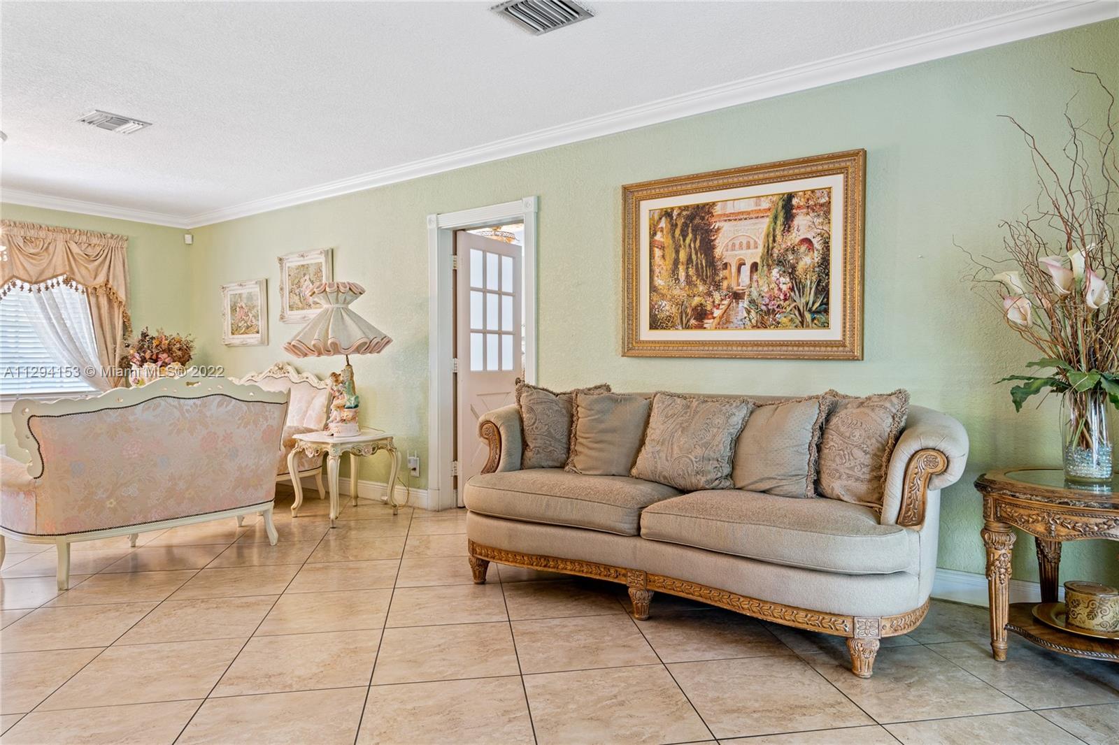 9901 Southwest 35th Terrace Miami, FL 33165 - Photo 16 of 50 a living room with furniture and a painting on the wall