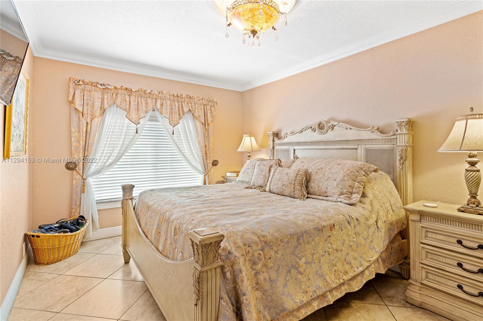 9901 Southwest 35th Terrace Miami, FL 33165 - Photo 17 of 50 a bedroom with a bed and a chandelier