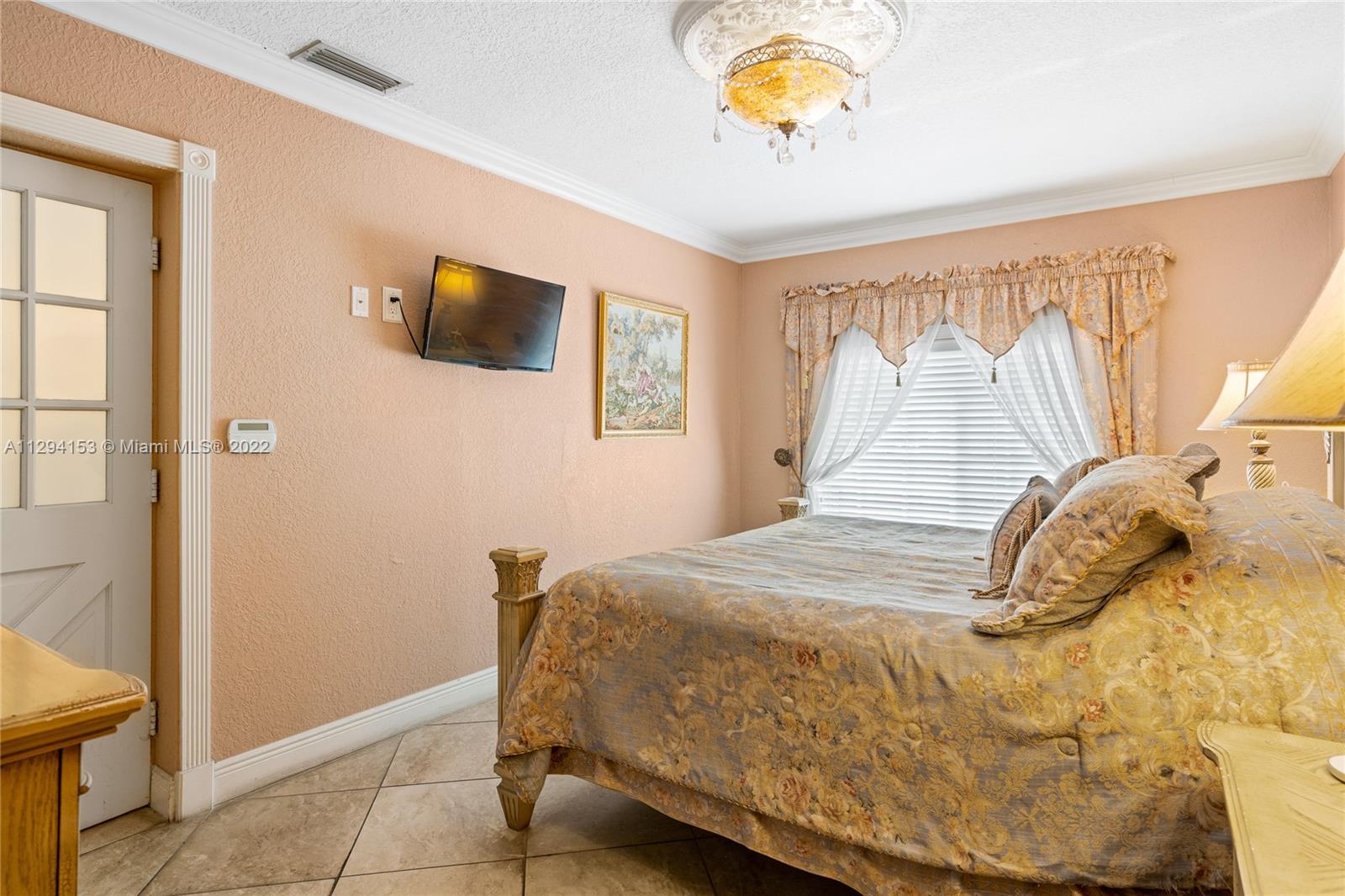 9901 Southwest 35th Terrace Miami, FL 33165 - Photo 18 of 50 a bedroom with a bed and a window