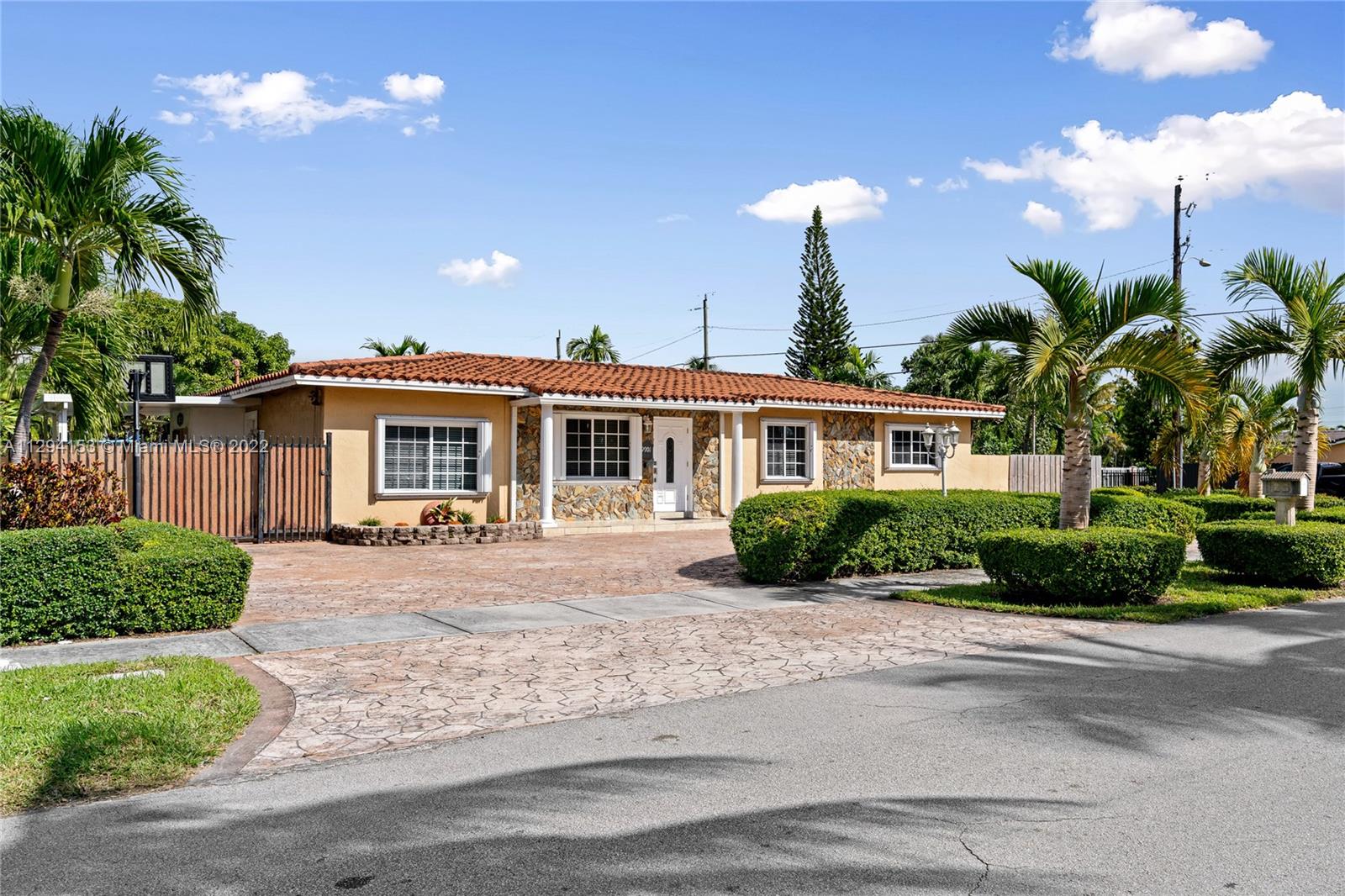 9901 Southwest 35th Terrace Miami, FL 33165 - Photo 2 of 50 a front view of a house with a yard and potted plants