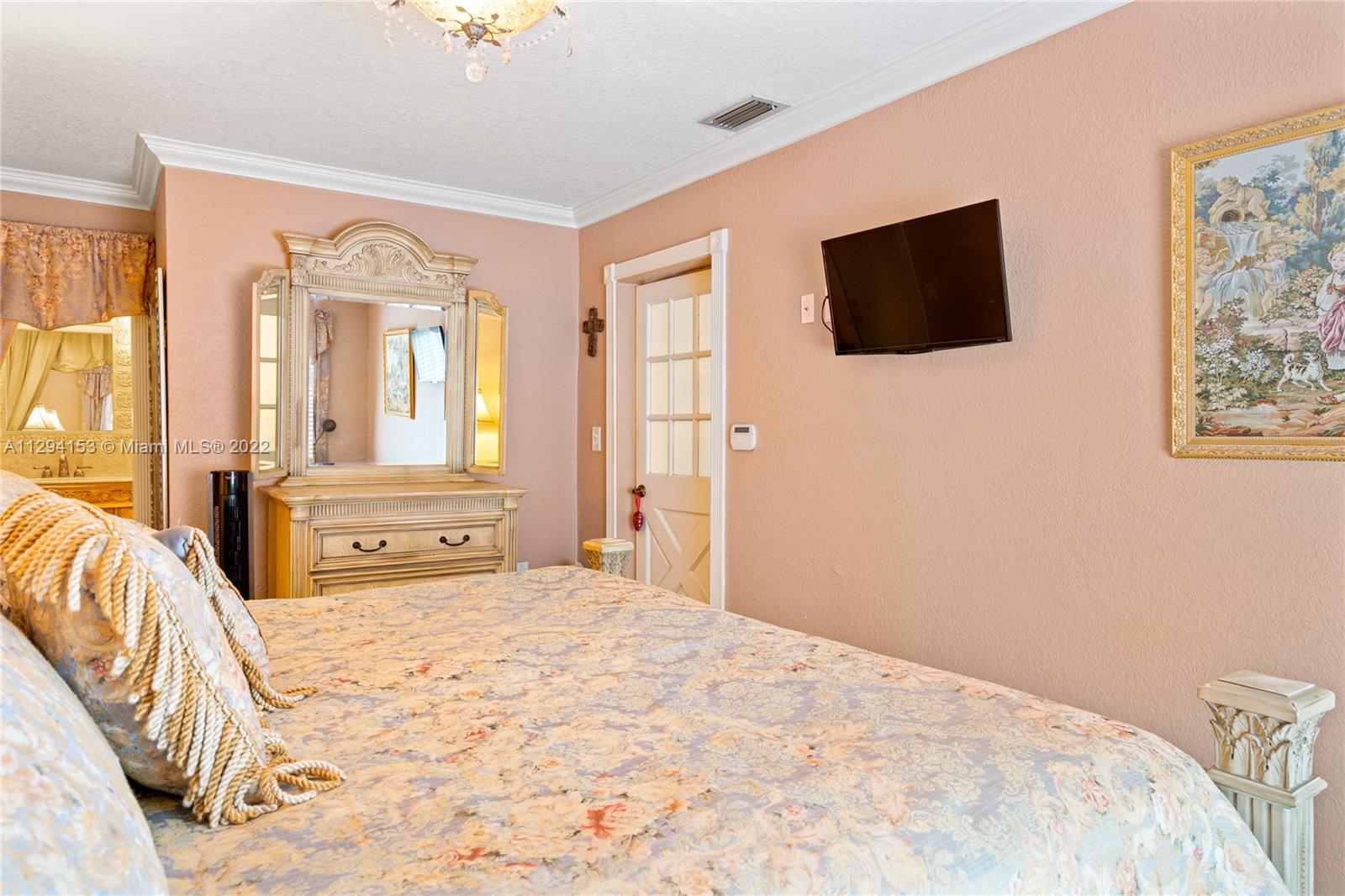 9901 Southwest 35th Terrace Miami, FL 33165 - Photo 22 of 50 a spacious bedroom with a bed and a flat screen tv