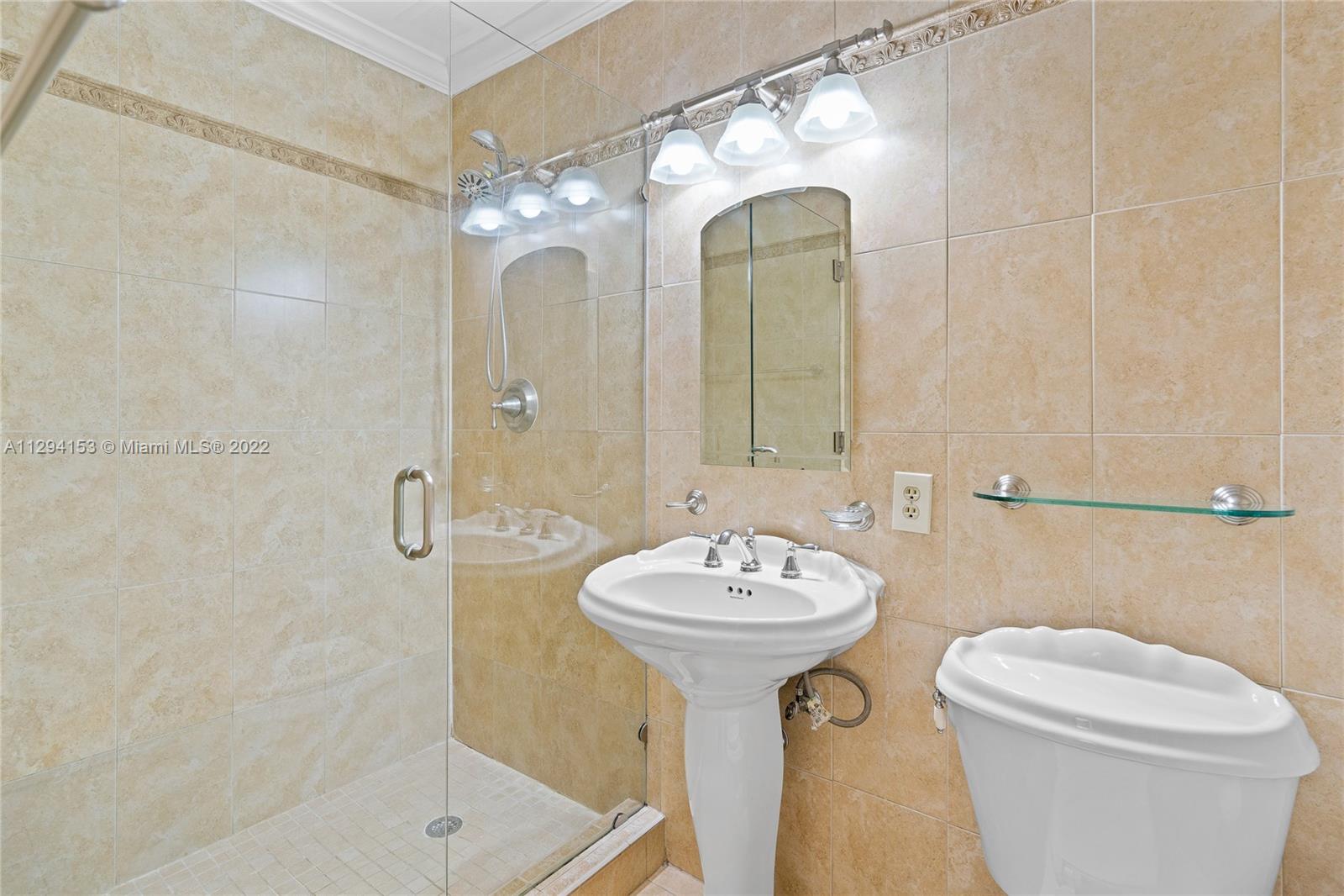 9901 Southwest 35th Terrace Miami, FL 33165 - Photo 27 of 50 a bathroom with a sink mirror toilet and shower