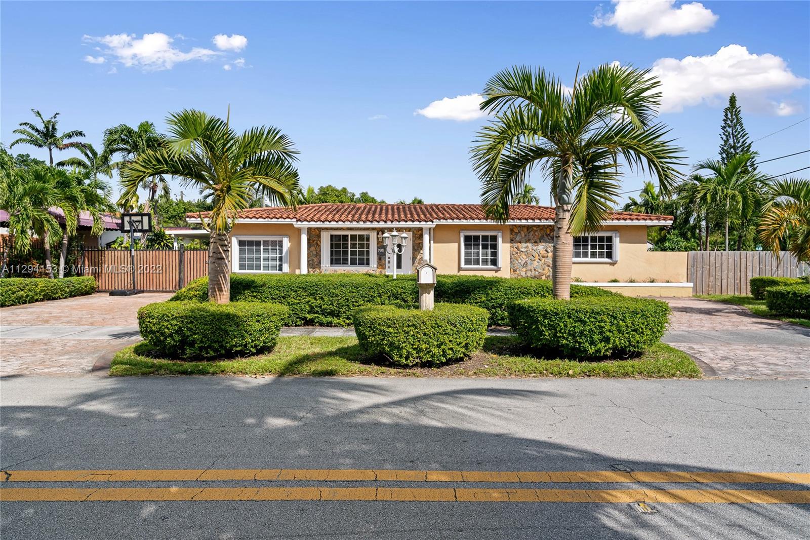 9901 Southwest 35th Terrace Miami, FL 33165 - Photo 3 of 50 a front view of a house with a yard and potted plants
