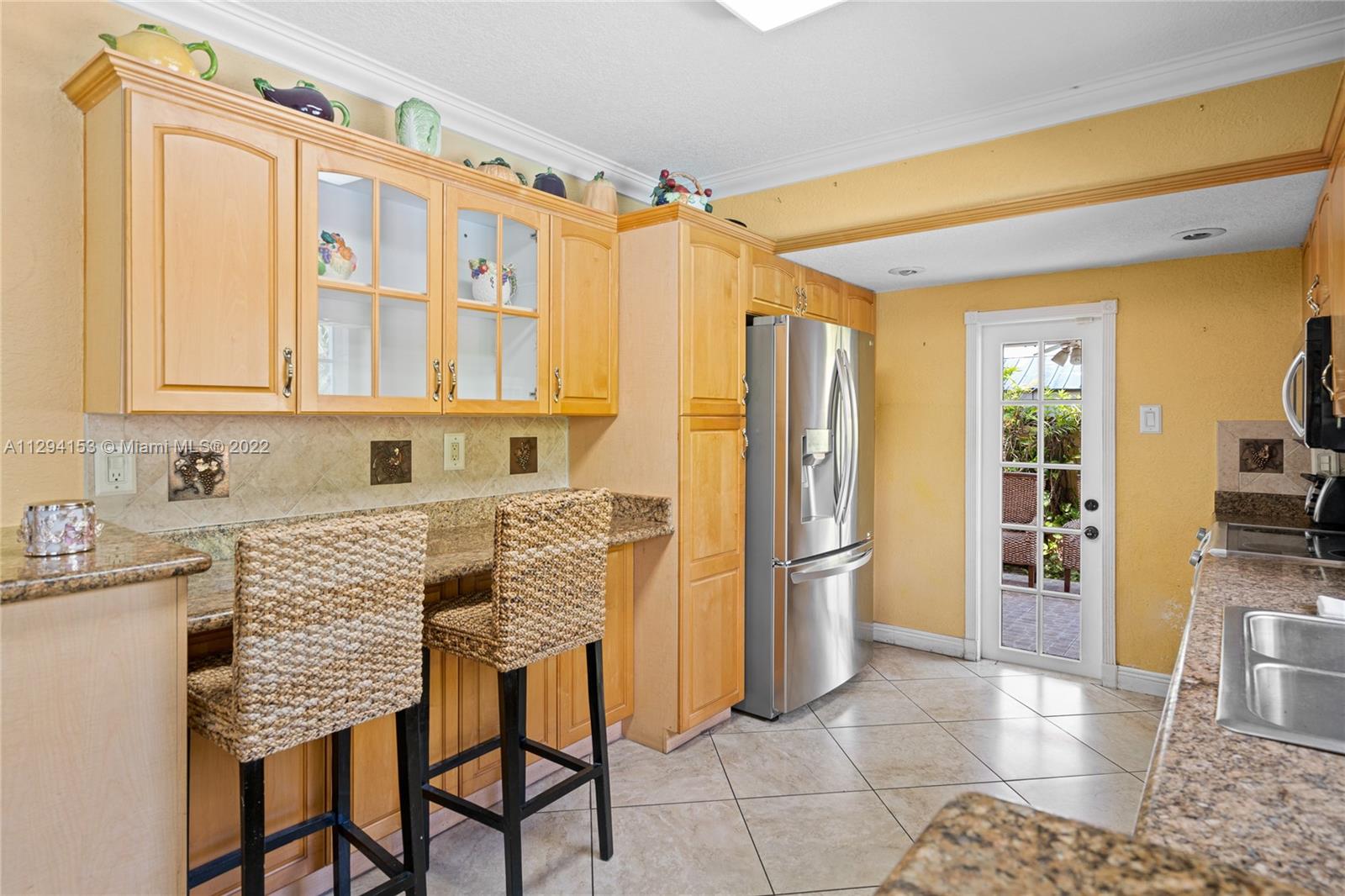 9901 Southwest 35th Terrace Miami, FL 33165 - Photo 31 of 50 a kitchen with stainless steel appliances granite countertop a refrigerator and a sink