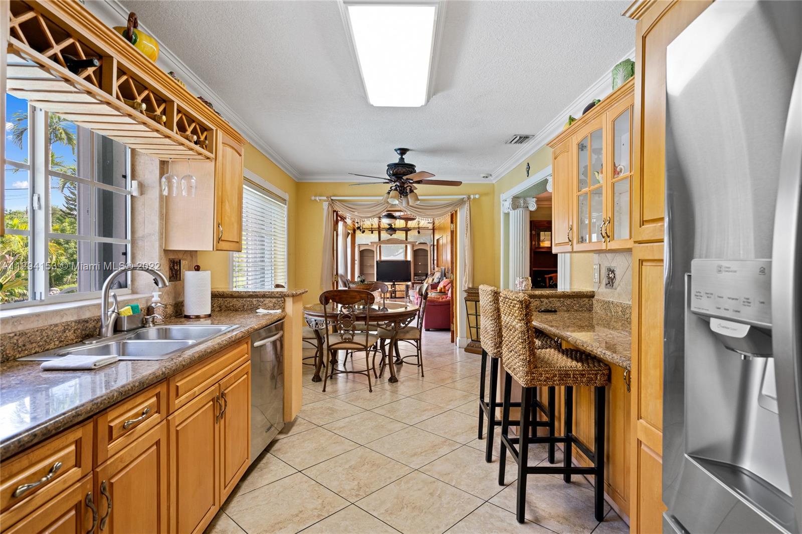 9901 Southwest 35th Terrace Miami, FL 33165 - Photo 34 of 50 a large kitchen with kitchen island granite countertop a sink and a large window