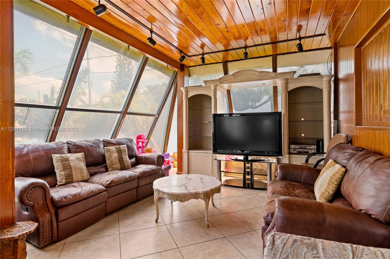 9901 Southwest 35th Terrace Miami, FL 33165 - Photo 37 of 50 a living room with furniture and a flat screen tv