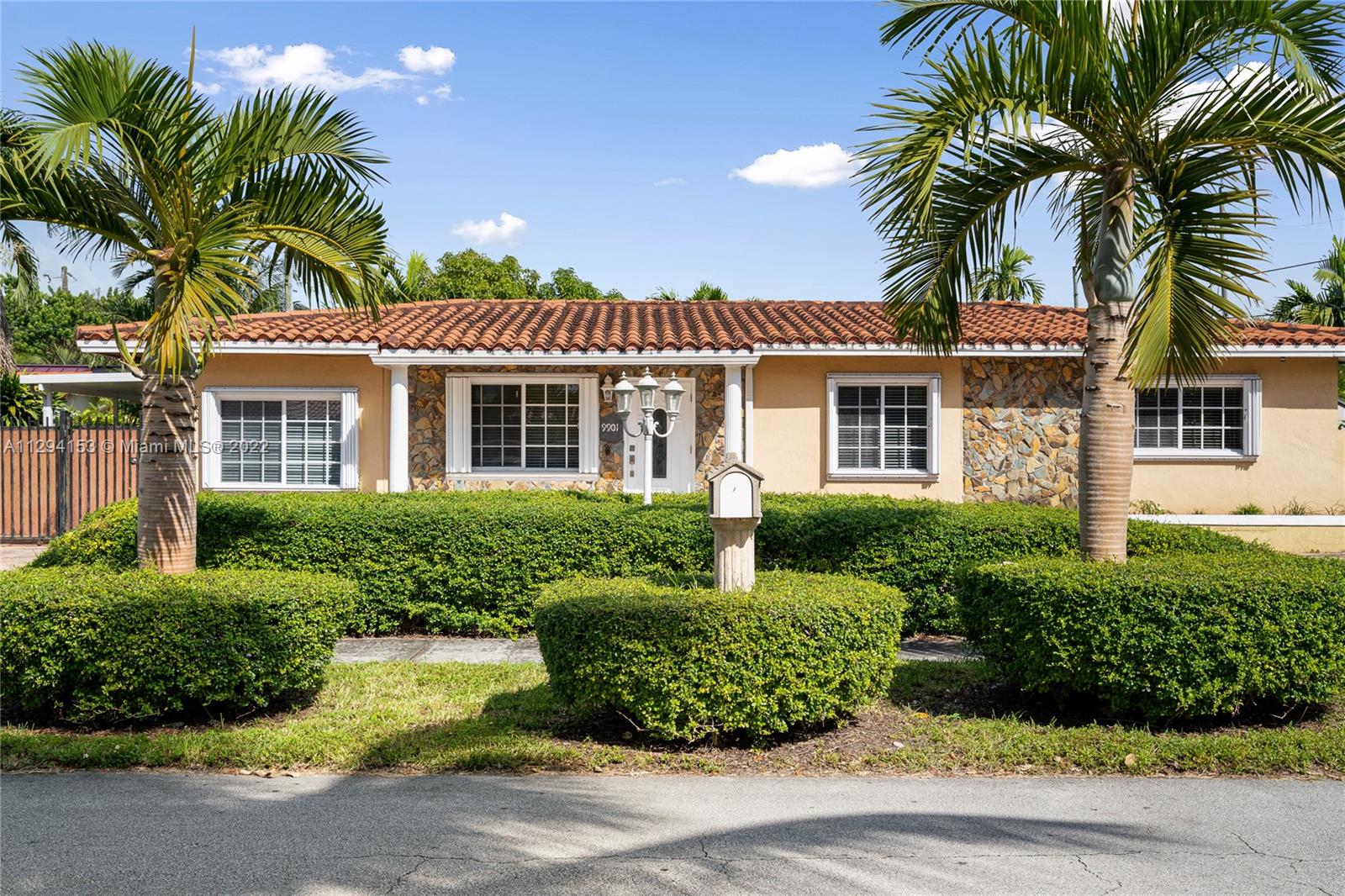 9901 Southwest 35th Terrace Miami, FL 33165 - Photo 4 of 50 a front view of a house with a garden