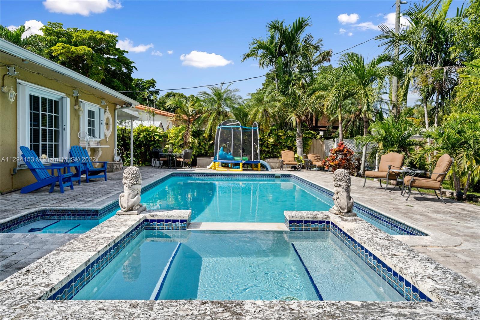 9901 Southwest 35th Terrace Miami, FL 33165 - Photo 45 of 50 a view of a swimming pool with lounge chair