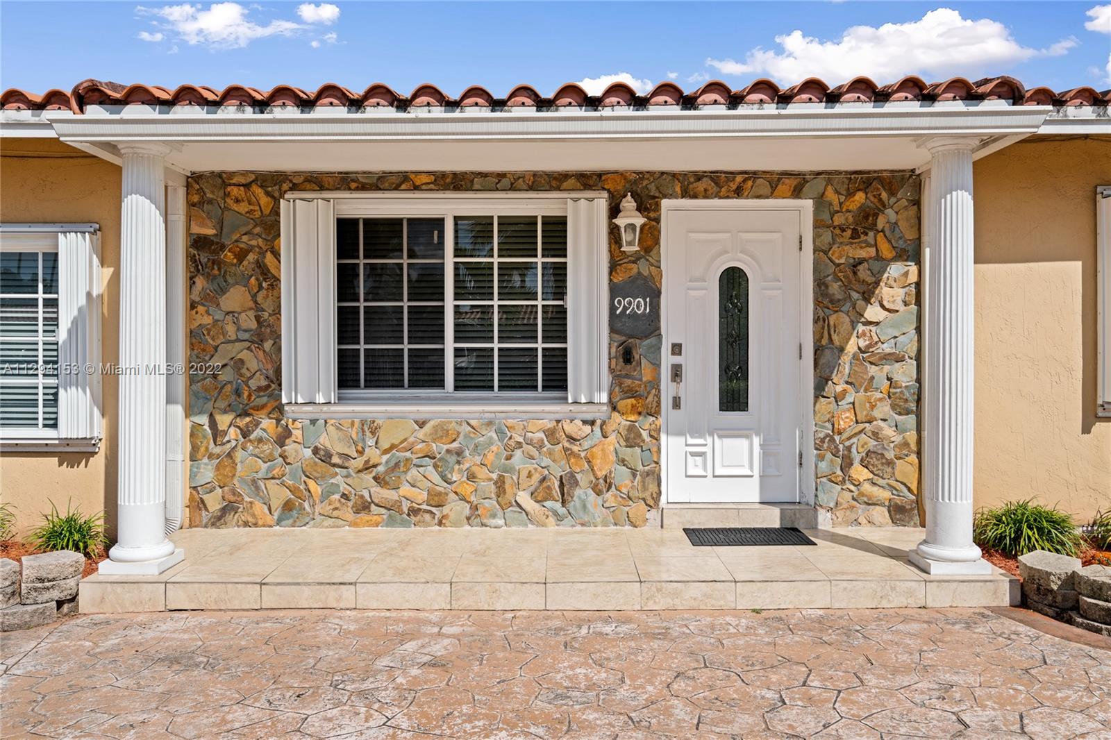 9901 Southwest 35th Terrace Miami, FL 33165 - Photo 7 of 50 a front view of a house with many windows