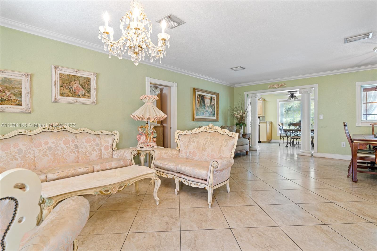 9901 Southwest 35th Terrace Miami, FL 33165 - Photo 8 of 50 a living room with furniture and a chandelier