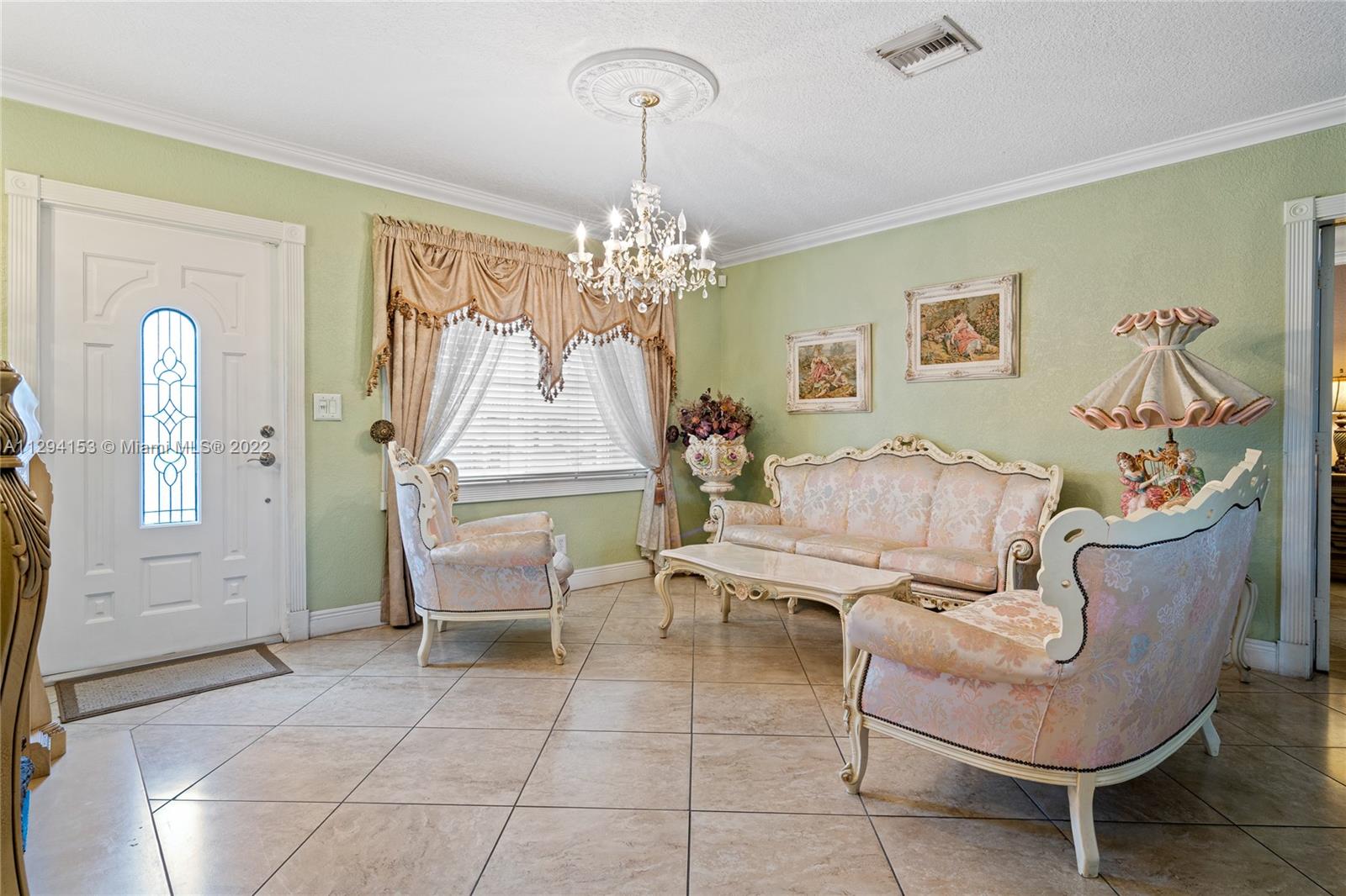 9901 Southwest 35th Terrace Miami, FL 33165 - Photo 9 of 50 a living room with furniture and a chandelier