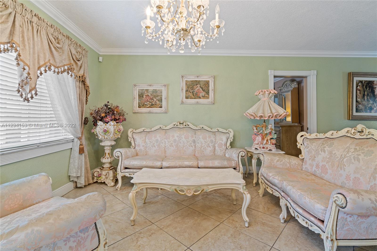 9901 Southwest 35th Terrace Miami, FL 33165 - Photo 10 of 50 a living room with furniture and a chandelier