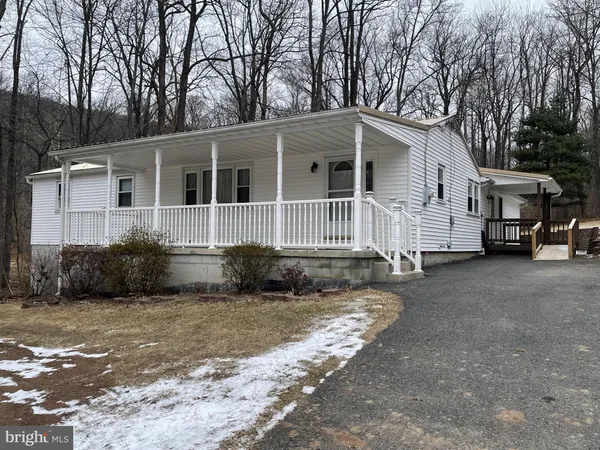 a view of a house with a yard covered in snow