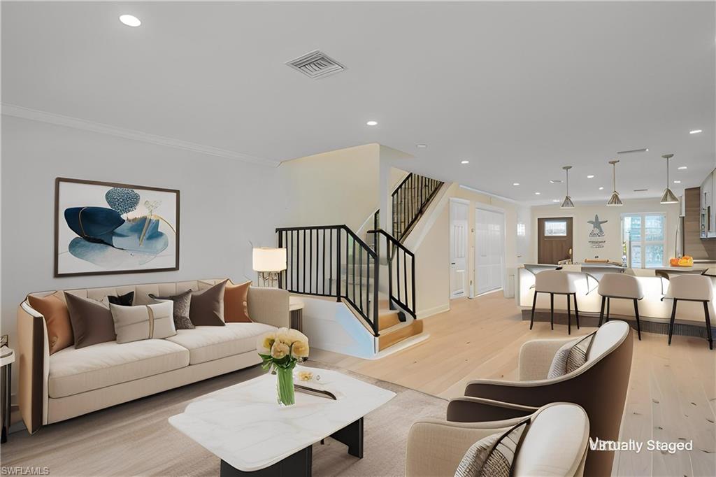 1070 6th Street South, Unit 1070 Naples, FL 34102 - Photo 14 of 41 Virtually Staged to show placement of furniture and other options. Living room with light wood finished floors, recessed lighting, ornamental molding, and french doors