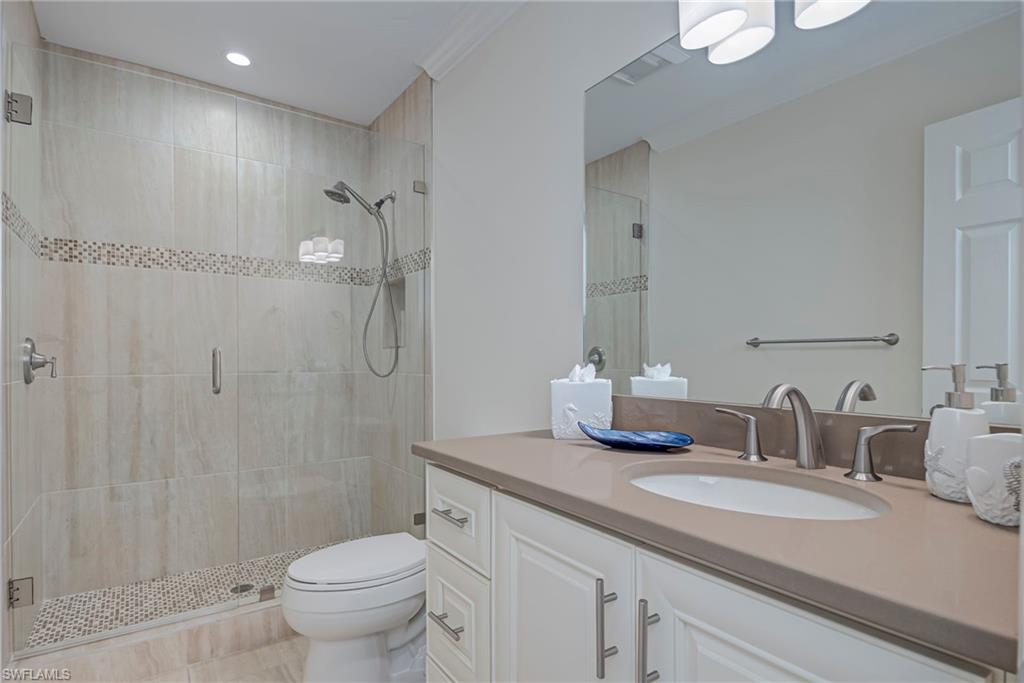 1070 6th Street South, Unit 1070 Naples, FL 34102 - Photo 27 of 41 This is the bathroom in the hallway when you come up the stairs. Completly updated and neutral. Bathroom with vanity, a shower stall, and recessed lighting