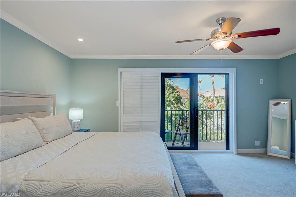 1070 6th Street South, Unit 1070 Naples, FL 34102 - Photo 30 of 41 Large Primary Suite! Bedroom with crown molding, light colored carpet, a ceiling fan, access to exterior, and recessed lighting