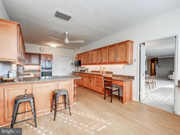 a kitchen with stainless steel appliances granite countertop a stove a sink dishwasher and a refrigerator